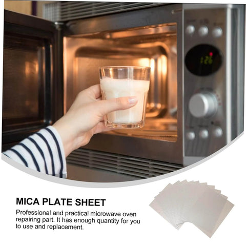 Hand placing glass in microwave open door with 12 Pieces Mica Sheets For Microwave Oven Waveguide Cover Heat Resistant Fireproof Insulation Pads