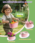 Child holding pink metal bucket from 8 Piece Kids Gardening Set With Real Metal Tools Metal Basket And Tote Gloves Watering Can Shovels Rake