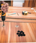 Get This Sweet Silicone Screw Plug Kit With A Cool Slot Design For Furniture And Cabinets And Ensure It Stays Put While Adding Style To Home Decor Today. Black silicone screw hole plugs on wood panel with drill and furniture repair work.