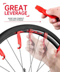 Three Pack Bicycle Tire Levers For Road And Mountain Bikes Heavy Duty Self Lubricating Plastic Rim Safe Levers For Quick Easy Tire Removal Tool Without Scratching Rims in use for removing a tire.