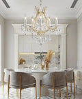 Gold 5 Light Maria Theresa Crystal Chandelier With Adjustable Chain Up To 52 Inches E12 Bulb Ready in elegant dining room setting.