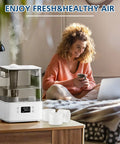 Woman using laptop with 30 Pack Top Fill Humidifier Replacement Filters That Fit Classic 160 150 200S 300 LV600S visible on table