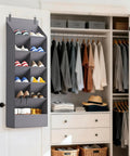 Six Tier Over The Door Shoe Organizer With Deep Fabric Pockets Keeps Your Kicks Neat Holds Up To 12 Pairs Of Sneakers And Boots For Bedroom Closet Or Dorm Room Organization In Gray in a closet setup.