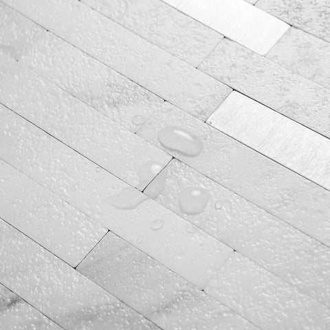 Close-up of Faux Stone Peel And Stick Backsplash Tiles 20 Sheets White Marble Look PVC Wall Tiles with water beads on surface