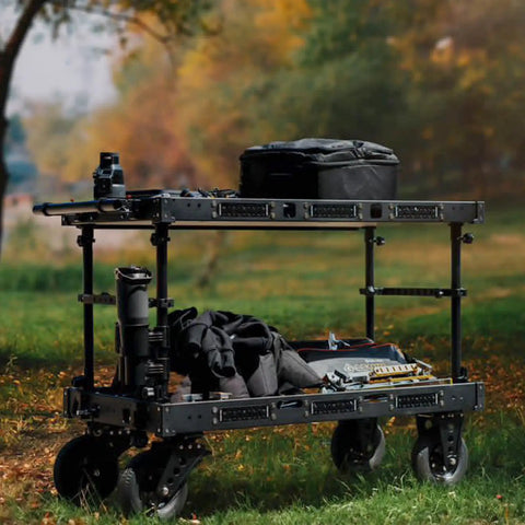 Heavy Duty Video Production Camera Cart Workstation For Filmmakers And Directors Smooth Rolling Studio Gear Stand with camera and bags outdoors.