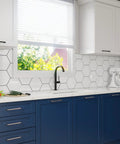Modern kitchen with blue cabinets featuring polished chrome 5 inch hole center cabinet handles in solid stainless steel from Tosca Collection