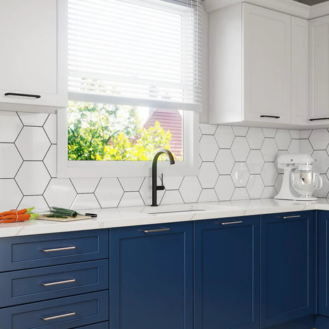 Modern kitchen with blue cabinets featuring polished chrome 5 inch hole center cabinet handles in solid stainless steel from Tosca Collection