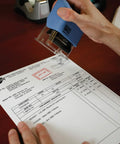 Self Inking Date Stamp Featuring Received Plus Date Readout And Bold Red Ink On Heavy Duty Plastic Body in use on invoice.