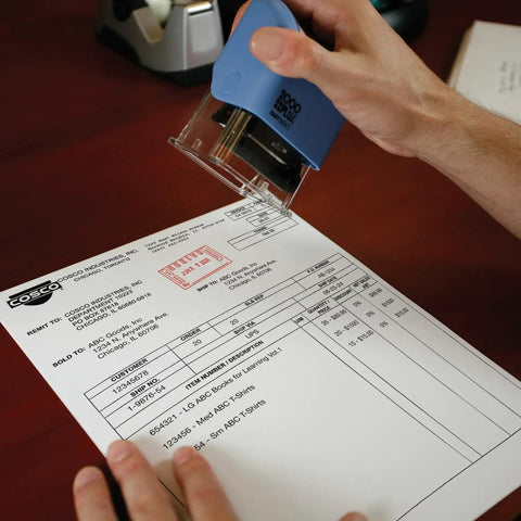 Self Inking Date Stamp Featuring Received Plus Date Readout And Bold Red Ink On Heavy Duty Plastic Body in use on invoice.