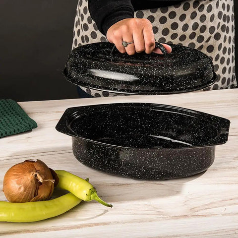 Oval 13 Inch Roaster With Lid Enameled Steel Pan That Holds Up To 7 Lb Poultry Or Roast Heat Resistant To 932 Degrees Fahrenheit Ideal For Two Even Cooking No Fuss Dinners, shown with lid being lifted, black speckled design.