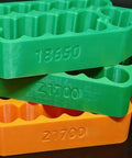 Grab And Go Insulated Spot Welding Jig For 18650 And 21700 Lithium Cells Featuring Hella Secure Clamps Safe Alignment Grid stacked in green and orange.
