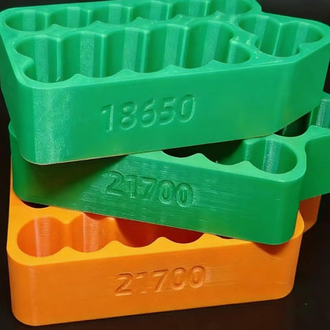 Grab And Go Insulated Spot Welding Jig For 18650 And 21700 Lithium Cells Featuring Hella Secure Clamps Safe Alignment Grid stacked in green and orange.