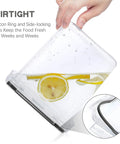 Clear airtight food storage canister held by hand showing silicone ring and side-locking lid with lemon slices and water inside.