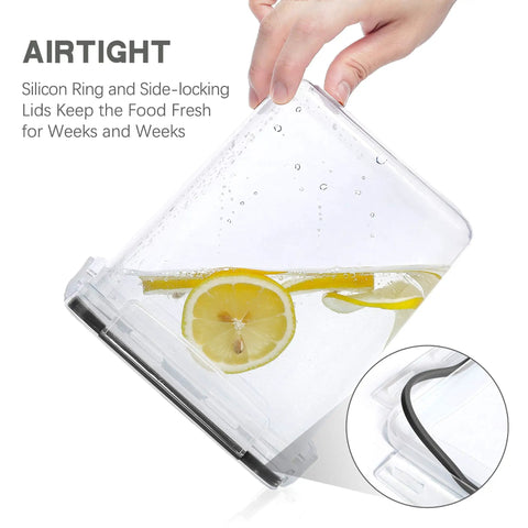 Clear airtight food storage canister held by hand showing silicone ring and side-locking lid with lemon slices and water inside.