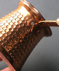 Close-up of copper Turkish Coffee Pot Cezve Set With 300ml Coffee Maker and Cup, Compact 11 By 8 By 8cm with textured design.