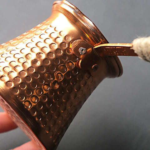 Close-up of copper Turkish Coffee Pot Cezve Set With 300ml Coffee Maker and Cup, Compact 11 By 8 By 8cm with textured design.