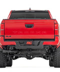 Rear view of truck with Rear Shackle Kit Beefed Up With D Rings And Rubber Isolators For Seven Eighths Pins Gloss Black Powder Coat