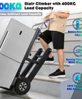 Upgrade Your Heavy Lifting Game With This Badass 1250 Watt Electric Stair Climbing Hand Truck on stairs hauling a large refrigerator.
