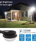 Beast Bright LED Barn Light 150W Dusk To Dawn Outdoor Yard Flood Light illuminating a house with ladder visible