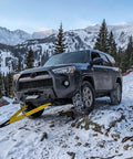 SUV using 3 Inch Wide 8 Foot Tree Saver Strap With Loops Heavy Duty Winch And Recovery Tow Strap 30000 Lbs MBS in snowy mountains