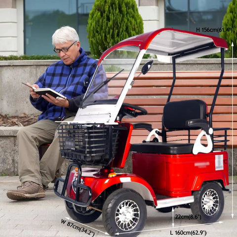 No Sweat Electric Mobility Scooter For Adults And Seniors With 28 Mile Range And 12 Mph Top Speed Hella Tough Frame parked beside a man reading.