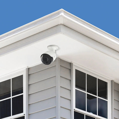 4K Ultra HD True Detect Outdoor Bullet Security Camera on house corner, crisp night vision up to 150ft, 90-degree field of view, IP66 weatherproof