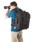 Photographer using Dual Mode DSLR Gear Backpack And Rolling Case For Cameras Lenses And Laptop Up To 15.4 Inches Converts