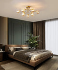 Sleek 9 Light Sputnik Chandeliers With Dope Brass Finish And Glass Globe Orbs in modern bedroom setting