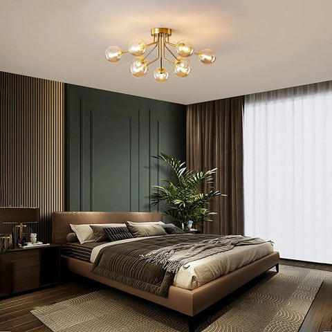 Sleek 9 Light Sputnik Chandeliers With Dope Brass Finish And Glass Globe Orbs in modern bedroom setting