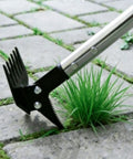 Close-up of 61 Inch Adjustable Weed Puller With Detachable Head, 2-In-1 Weed Rake And Crack Weeder in action on pavement.
