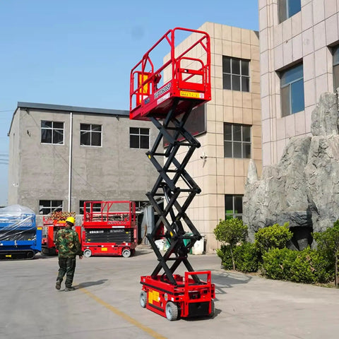 Straight Up Compact Scissor Lift Table Heavy Duty Mobile Material Hoist raised in outdoor setting next to buildings and a worker.