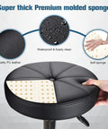 Close-up of black PU leather seat showing sponge padding of Round Rolling Stool With Wheels Height Adjustable Swivel Chair For Spa Salon Massage Black Comfy PU Leather Esthetician Stool With 360 Degree Rotation Easy To Clean Five Wheel Mobility.