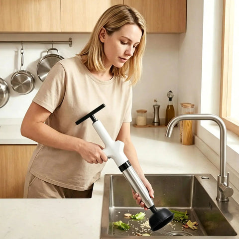 Clear Out Messy Blockages No Sweat With This Rechargeable Electric Plunger Built For Toilets Sinks And Floor Drains Plus An Ergonomic Grip That Makes Heavy Duty Work Smooth in woman’s hand over kitchen sink.