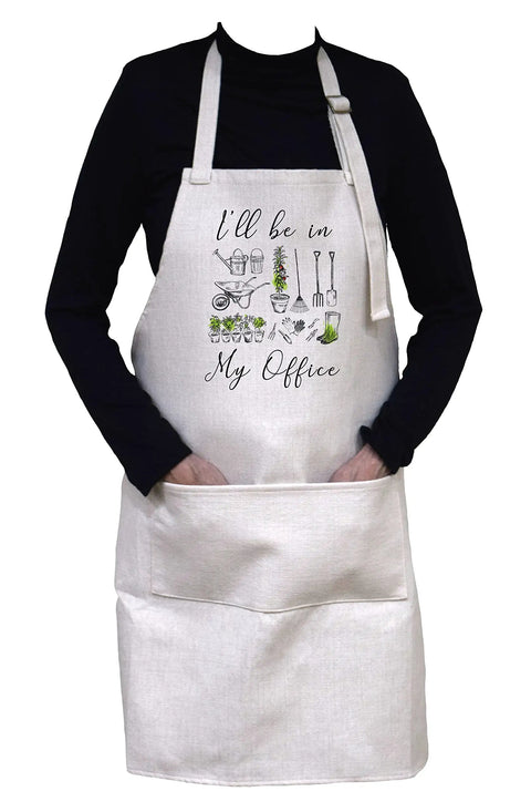 Person wearing Funny I'll Be In My Office Apron For Cooking Or Gardening With Adjustable Neck Strap And Large Front Pocket 33 By 25 Inches Heavy Duty 100 Percent Polyester In Cream Linen Tone.