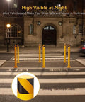 Solid As A Rock Yellow Safety Bollard Set Of Six, 42 Inch Tall Steel Posts With Anchor Bolts For Driveway Barriers, Traffic Control And Parking Lot Guards Built Like A Tank And Ready To Guard Your Space in a night setting.