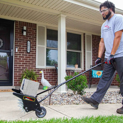 Man using 20 Inch Premium Push Spike Aerator With 3D Galvanized Steel Tines And Weight Tray For Deep Core Penetration on lawn.