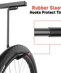 Close-up of a ceiling bike rack hook with rubber sleeve shown holding a bicycle tire, part of Ceiling Bike Rack For Garage And Home Storage Hang Indoor Bicycles Up To Two Horizontally Or Four Vertically With Adjustable Hooks 25 Inch Durable Steel Construction Rust Resistant Space Saving.