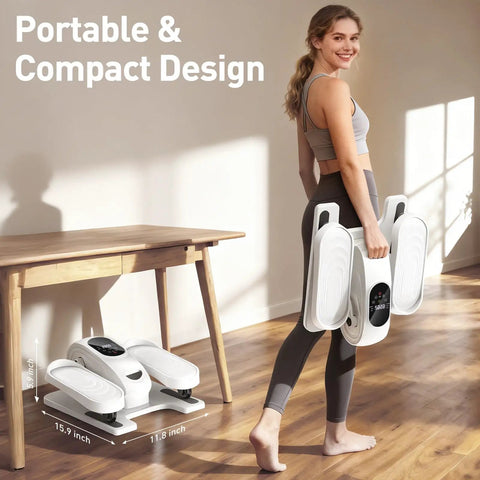 Woman carrying a portable under desk elliptical pedal exerciser near a table, showcasing compact design.