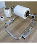 Heavy Duty All Metal Roll Holder Dispenser For Bubble Wrap Stretch Film And Foam Commercial Packing Stand with film roll and base.