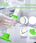 Person holding pro grade glass graduated cylinder set with 10ml size, green hex base, 3.3 borosilicate glass, lab tool features shown.