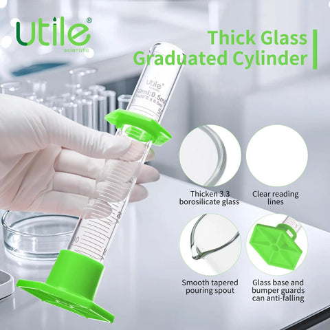Person holding pro grade glass graduated cylinder set with 10ml size, green hex base, 3.3 borosilicate glass, lab tool features shown.