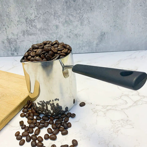 Turkish Coffee Pot And Milk Frothing Jug 21oz 600ml Stainless Steel Toroid Pitcher With Long Handle filled with coffee beans