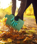 Person using an Adjustable Metal Leaf Rake Set With Telescopic Handle From Thirty Eight To Seventy Three Inches Twenty Five Tines Nineteen Inch Wide Includes Two 32 Gallon Leaf Bags And Scoops Heavy Duty Garden Rake For Lawns Shrubs Grass And Flower Beds to collect leaves
