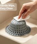 Cleaning Bathtub Drain Strainer Silicone Bathroom Stopper Fixture with a cloth in a sink, showing effective use.