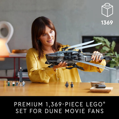 Woman holding Dune Atreides Royal Ornithopter Build Set 10327 for Adults Collectible Display Model with foldout wings.