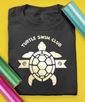 Electric Pearl Heat Transfer Vinyl Roll, 11.8 Inches By 3 Feet, Siser EasyWeed HTV next to a Turtle Swim Club shirt on yellow background.