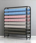 Heavy Duty Rolling Vinyl Storage Rack With Adjustable Rods For Wallpaper And Leather Rolls Slick Black Steel Craft Cart loaded with various wallpaper rolls.