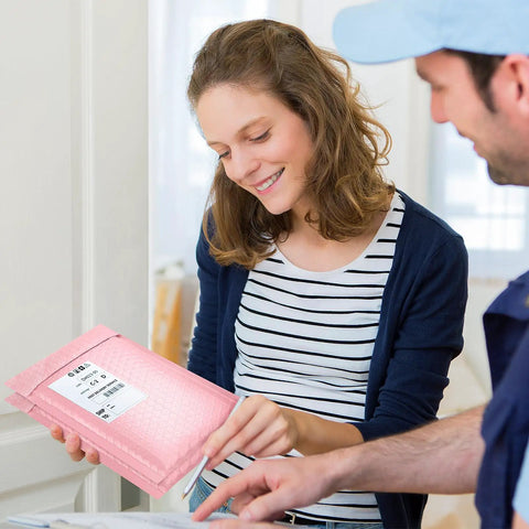 Woman holding Light Pink 4x8 Inch Bubble Mailers 50 Pack Self Seal Padded Poly Mailers For Small Biz Shipments