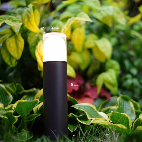 Low Voltage Pathway Lighting Kit 8 Pack Bollard Landscape Lights 2W 2700K Warm White LED Wired Path Lights 100 Lumens Metal Outdoor Brown Finish With Stake Connector For Walkways And Driveways next to green plants.