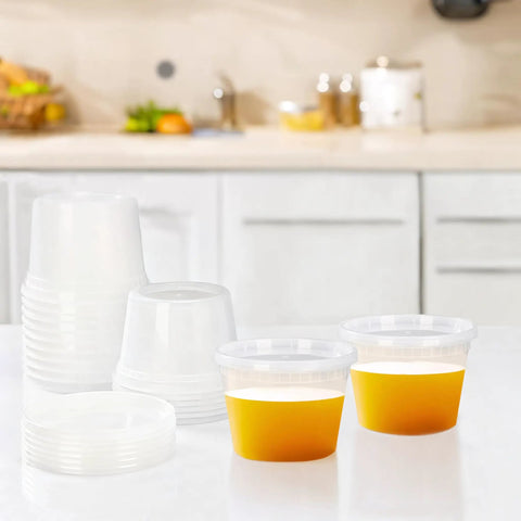 50 Pack 16 Oz Clear Plastic Deli Containers With Lids For Grab And Go Meal Prep, Airtight Leakproof Food Storage, BPA Free, Stackable, Microwave And Freezer Safe Everyday shown with orange liquid inside